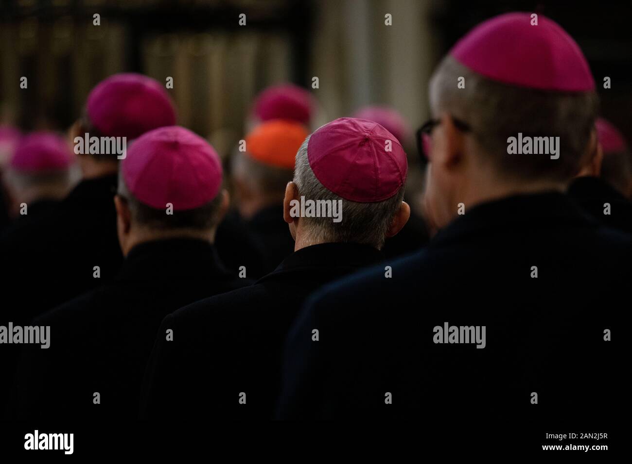 close -up of clerics in the amaranth zucchetto (form-fitting ecclesiastical skullcap) praying during the mass in the chapel Stock Photo