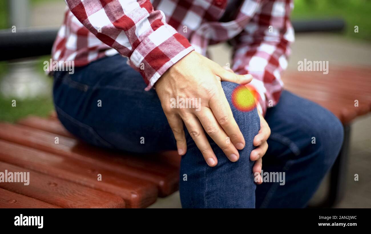 Man feels knee pain, sprained ligaments, dislocated kneecap, spot