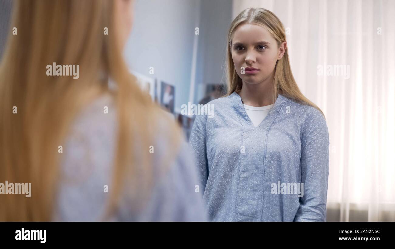 Teen looking at mirror reflection, upset about appearance, teenage ...