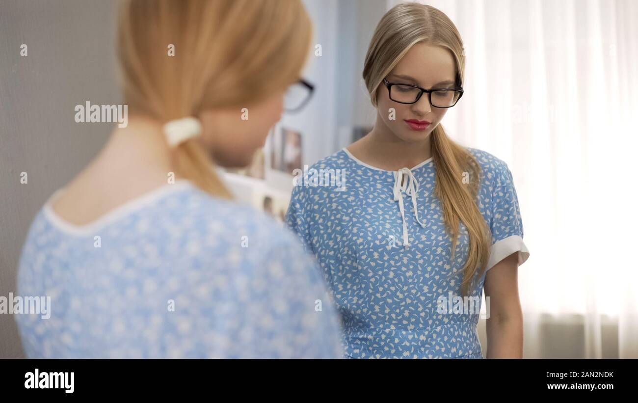 School girl with bright lipstick on lips feeling shame, unusual style, make up Stock Photo
