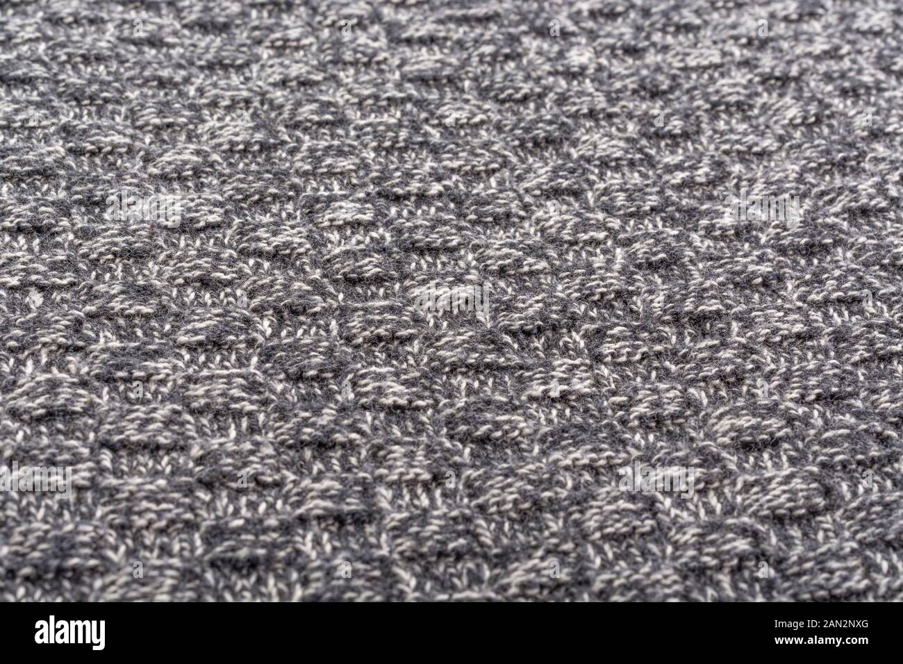 Close-up macro shot of knitted polyester fabric. Metaphor stitched in time, stitched up, warp and weft, UK textile industry. Stock Photo