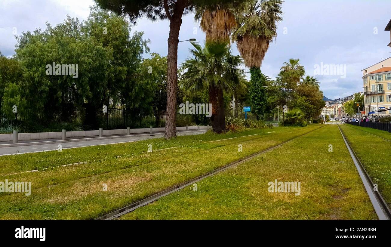 Green sunny street with railways, comfortable place for living, environment Stock Photo