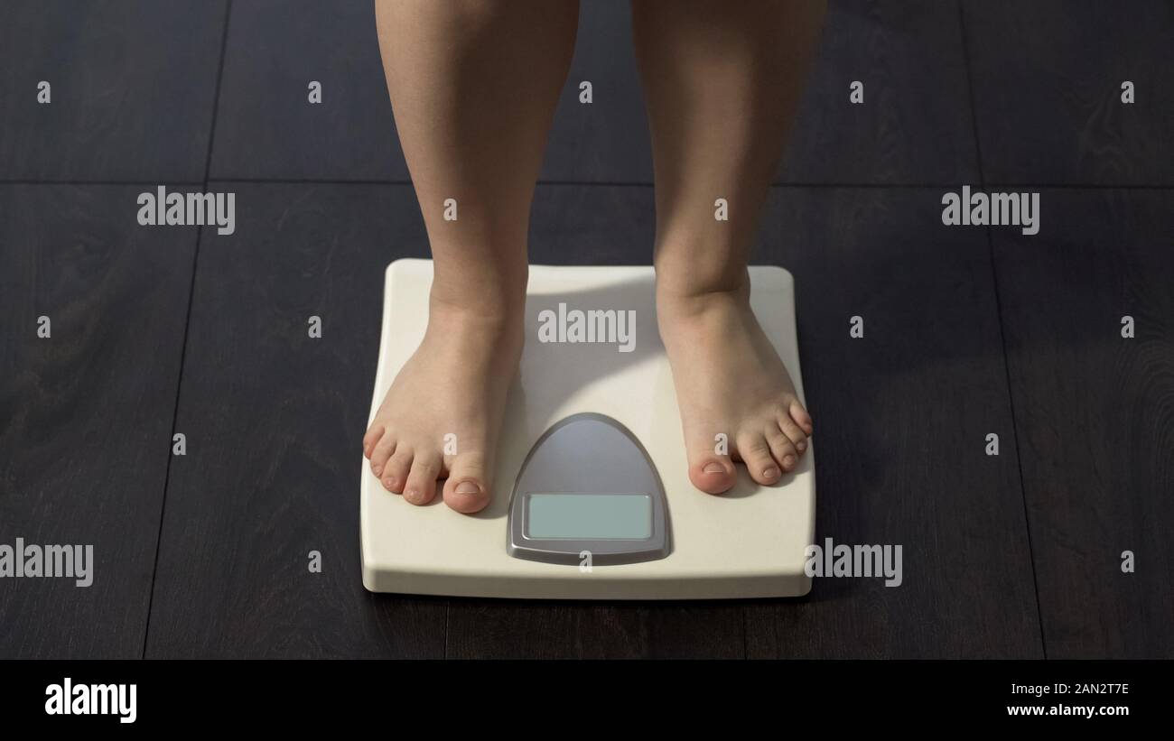 https://c8.alamy.com/comp/2AN2T7E/obese-girl-standing-on-electronic-scales-weight-loss-program-calorie-control-2AN2T7E.jpg