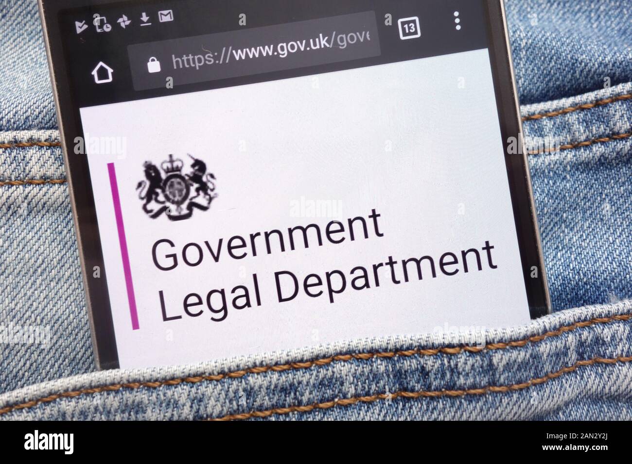 Gov.uk website displayed on smartphone hidden in jeans pocket Stock Photo