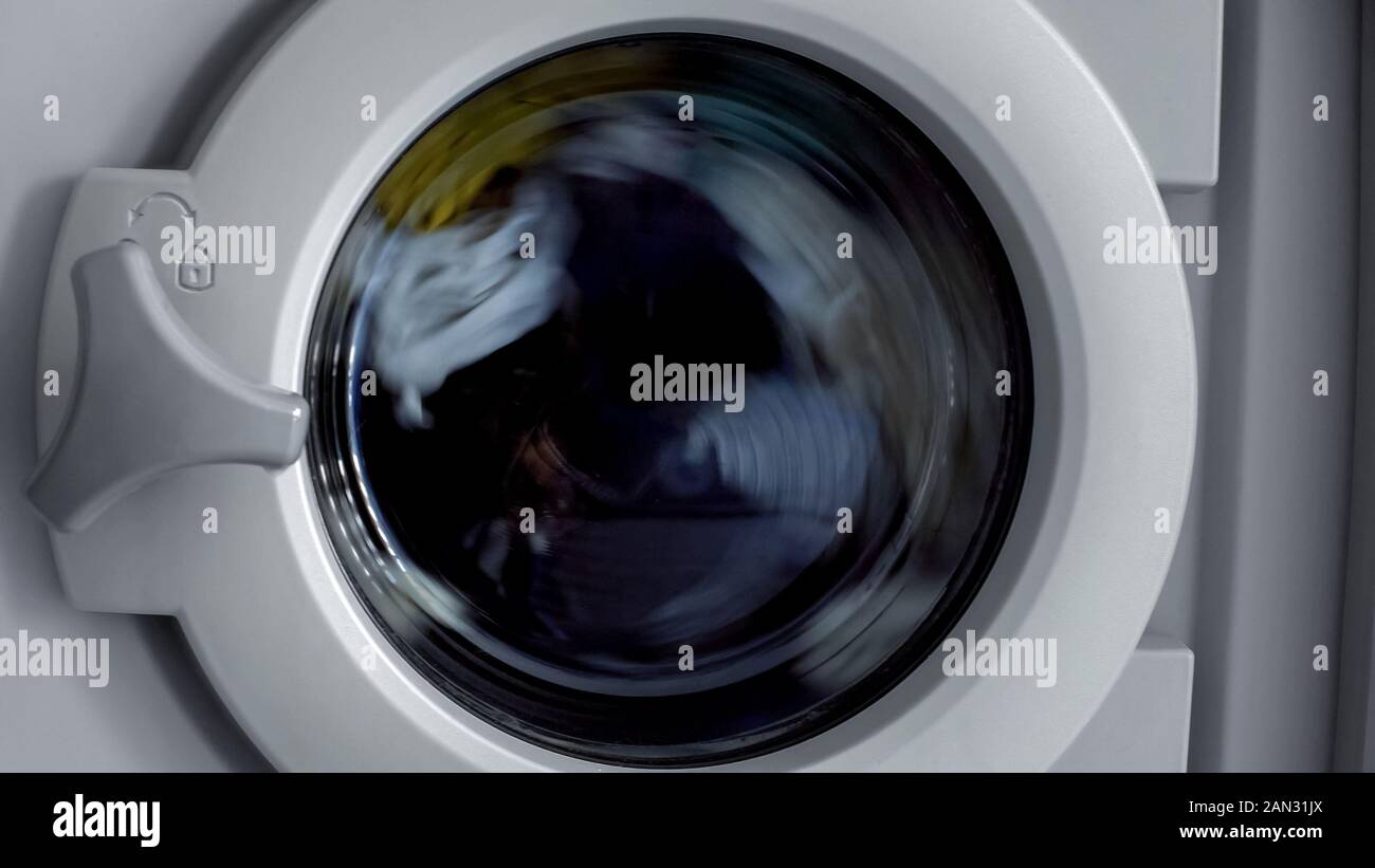 Washing machine cleaning clothes, laundry day at home, household ...