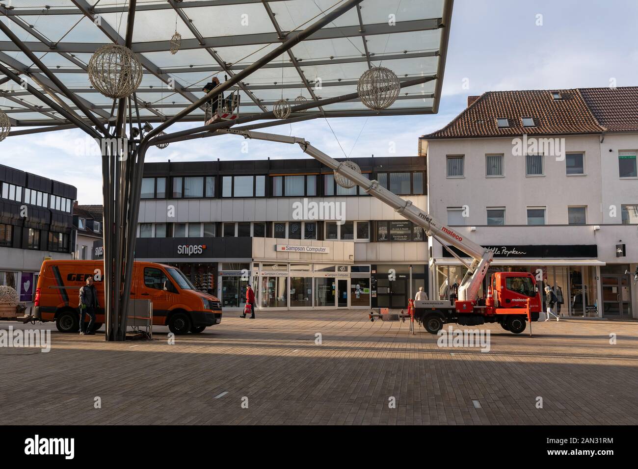 Best sign of christmas being over is when decoration disappear. Workers taking down christmas lights in Wolfsburg, Germany. Stock Photo