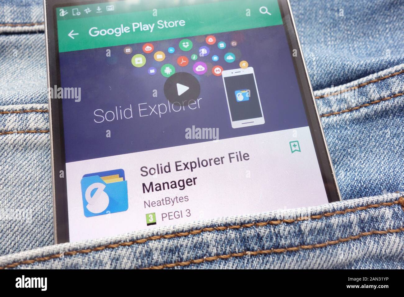 Solid Explorer File Manager app on Google Play Store website displayed on smartphone hidden in jeans pocket Stock Photo