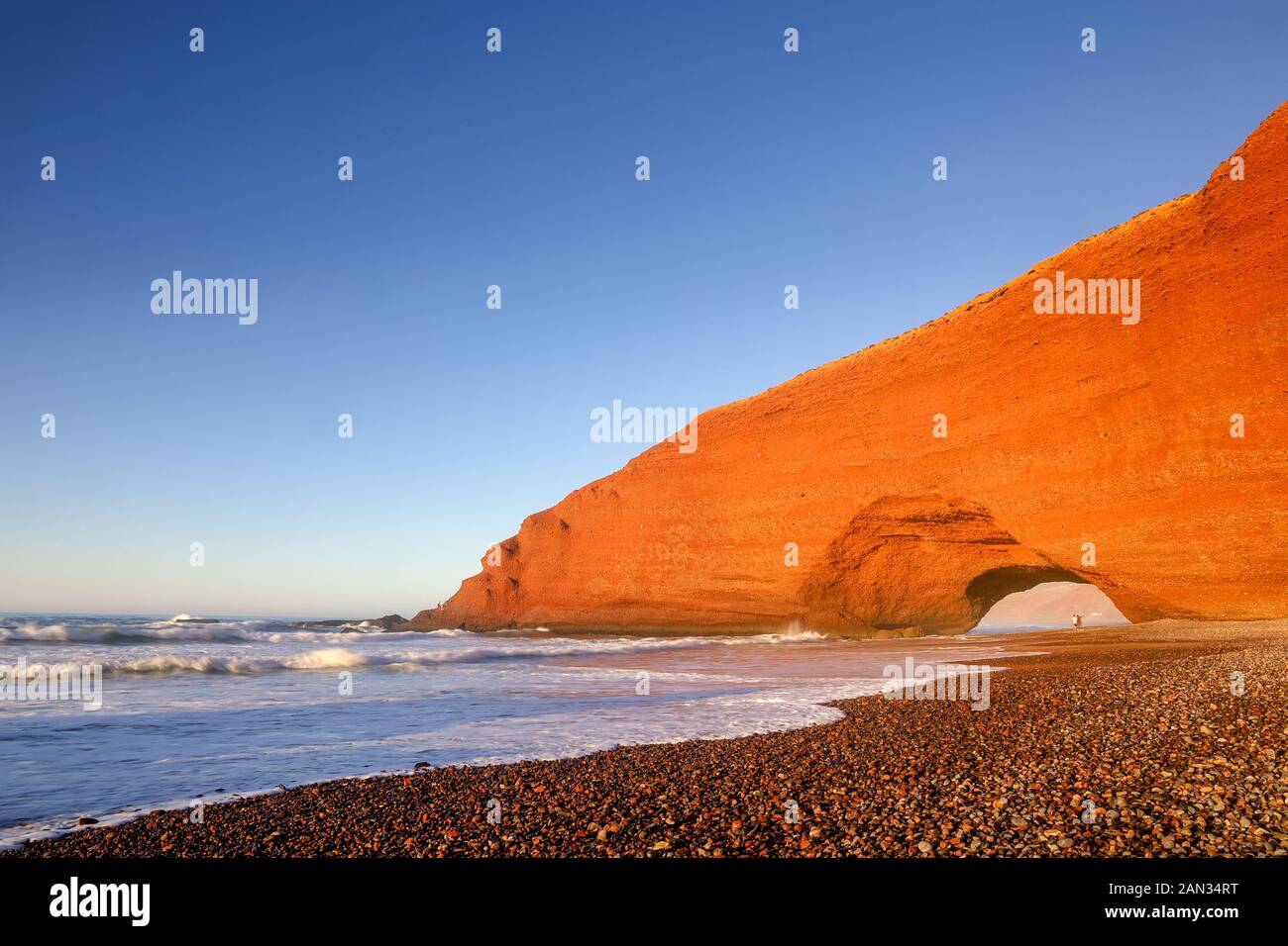 Natural stone arch at legzira beach with beautiful red colors, Sidi Ifni, Morocco Stock Photo