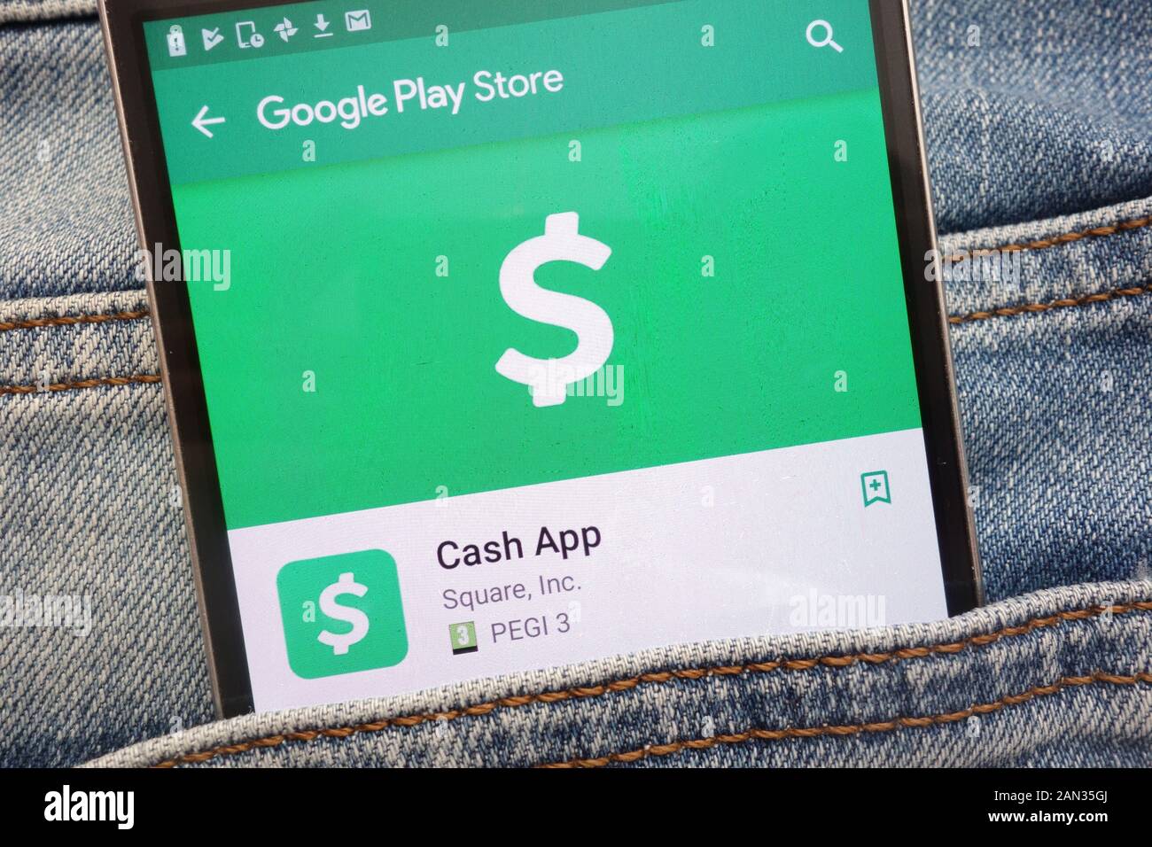 Cash App on Google Play Store website displayed on smartphone hidden in jeans pocket Stock Photo