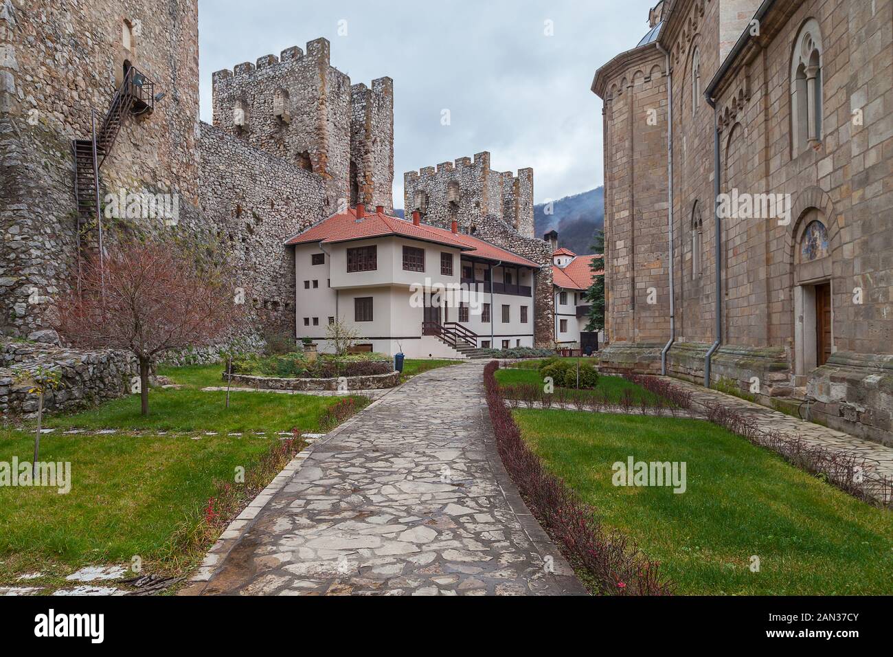Beautiful backyard and park inside the fortress walls on Manasija monastery. green grass, defensive towers and rocky pavement Stock Photo