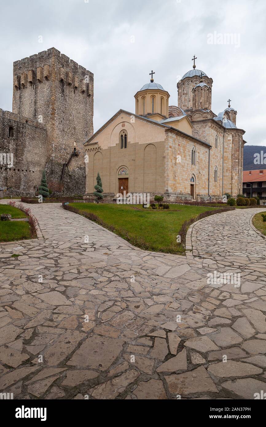 Beautiful orthodox Manasija monastery, surrounded by protective fortress walls, with wooden entrance doors, famous symbol of Christianity and popular Stock Photo