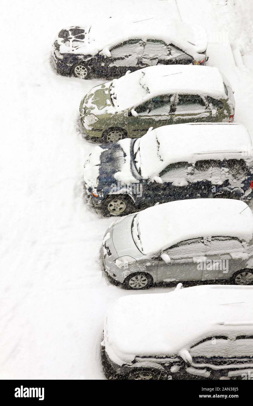 Cars on a street parking covered in snow Stock Photo - Alamy