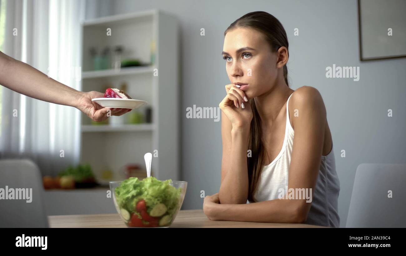 Lean Girl Choosing Between Salad And Cake Healthy Diet Vs High Calorie Food Stock Photo Alamy