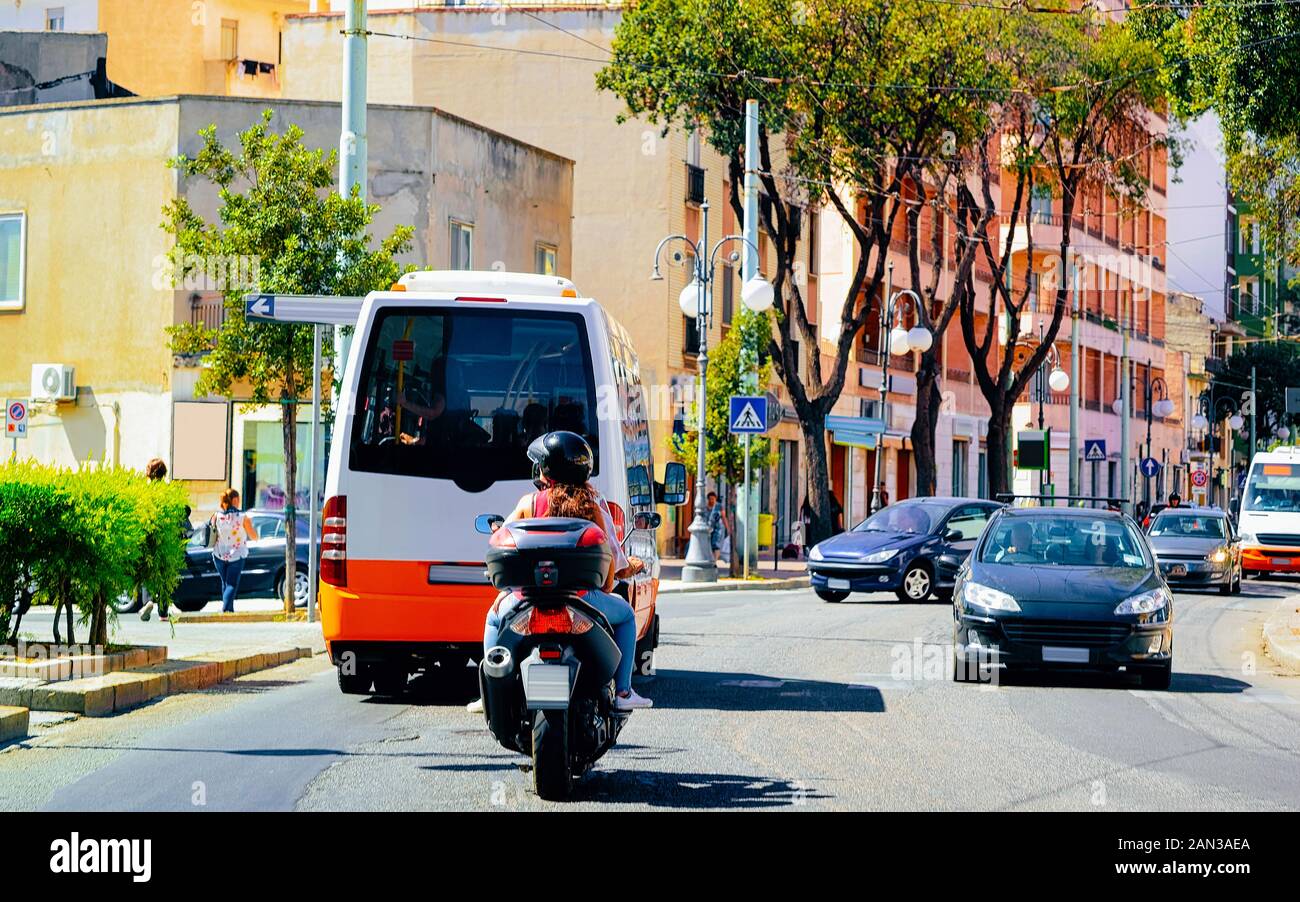 Street view on Road with cars scooter shuttle bus Cagliari reflex Stock