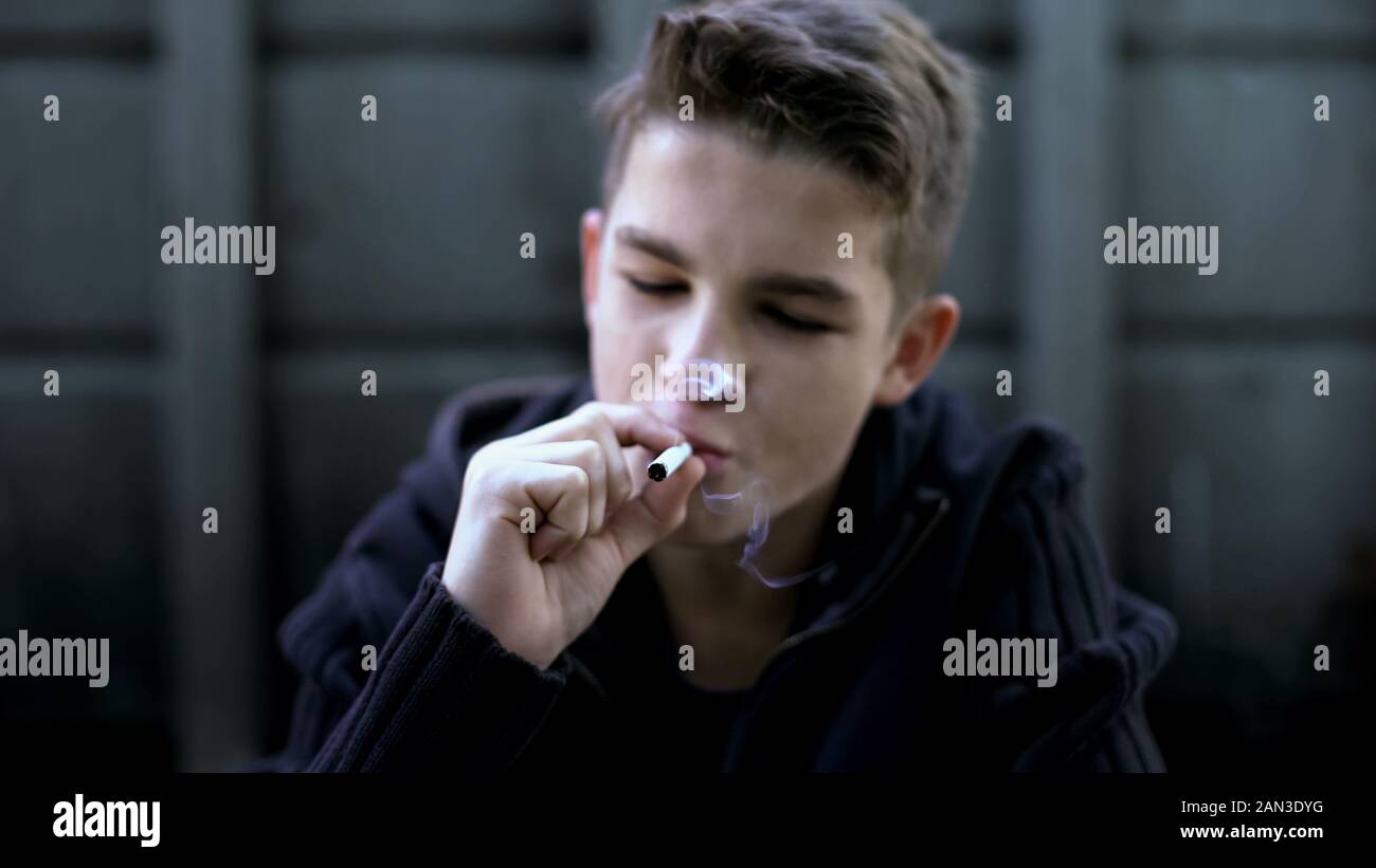 Teenager smoking cigarette, hiding from parents, bad habits, awkward