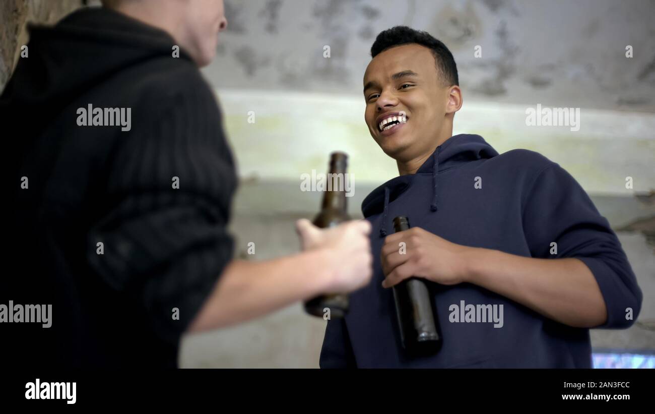 Boozy teenage boys talking, drinking beer, alcohol addiction among young people Stock Photo