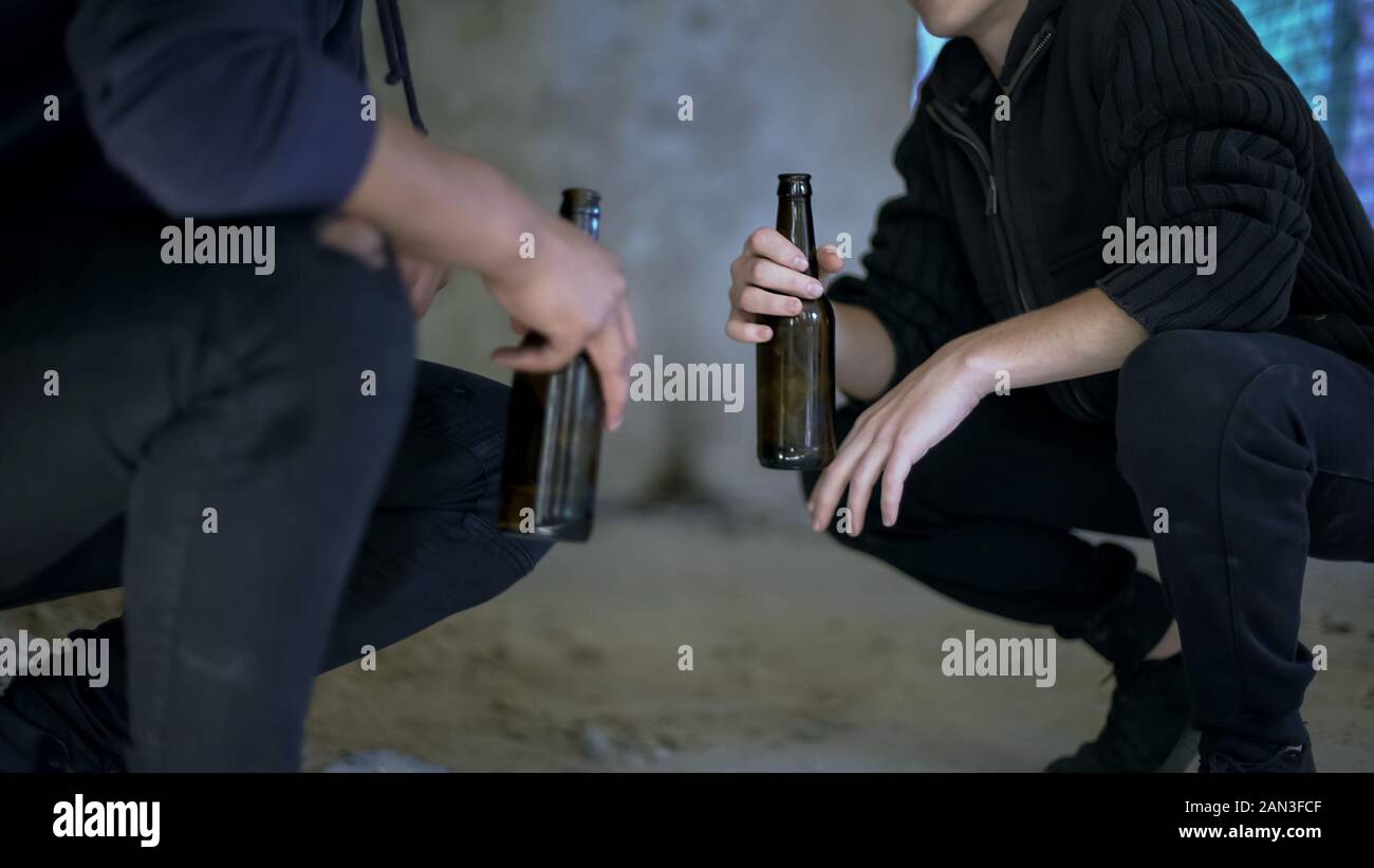 Teens drinking beer and communicating, alcohol addiction, youth entertainment Stock Photo