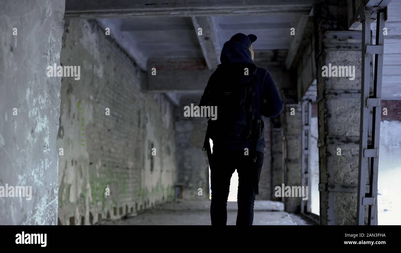 Teenage boy walking in abandoned house, dangerous place, risk of ...