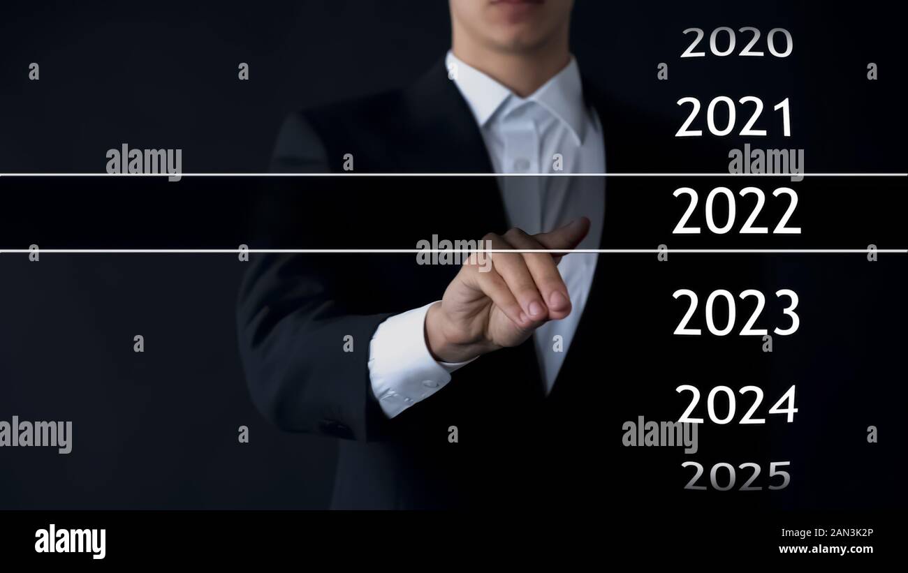 Man finds 2022 year in virtual archive, collection of statistics, annual reports Stock Photo
