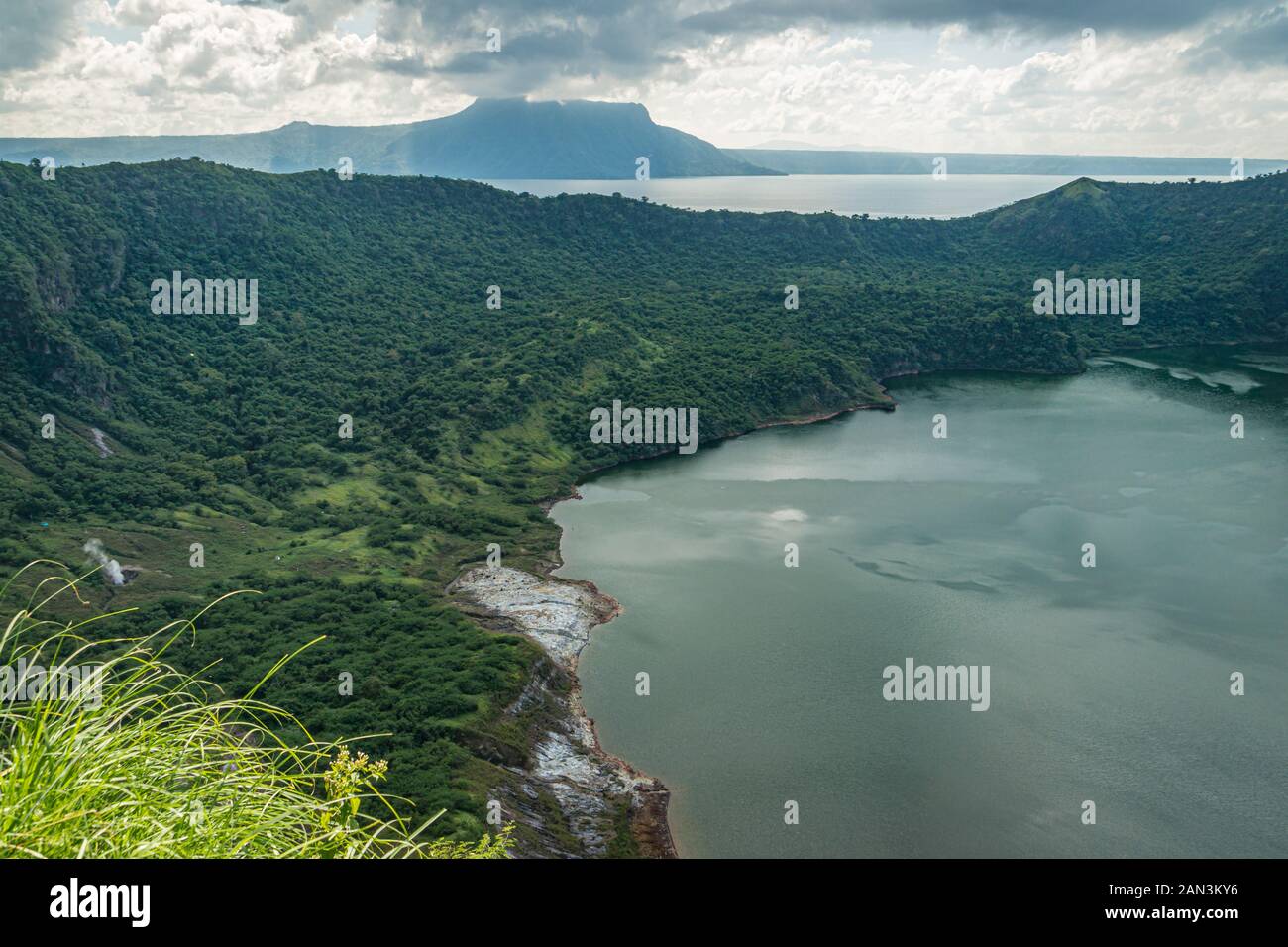 Steam escaping from the sides of crater lake of the active Taal Volcano. Stock Photo