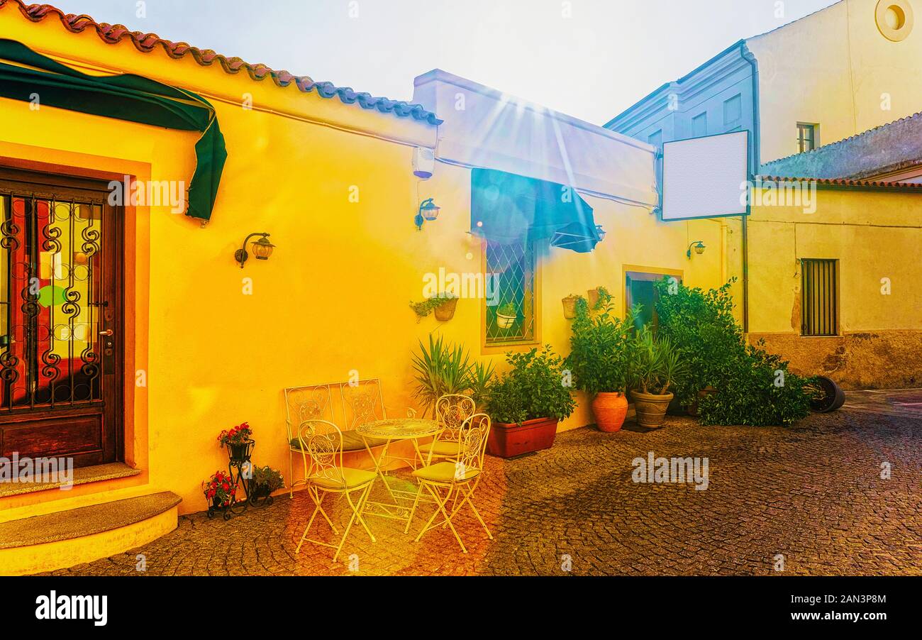 Cozy sidewalk cafe with flower pots in Olbia reflex Stock Photo