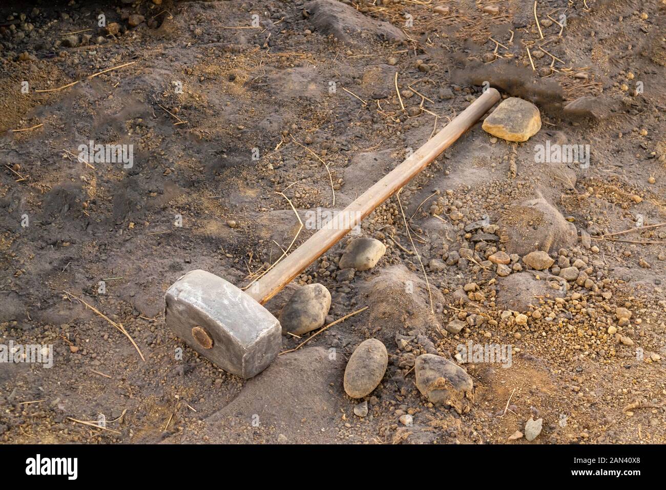 Dirty sledgehammer on soil and sand Stock Photo