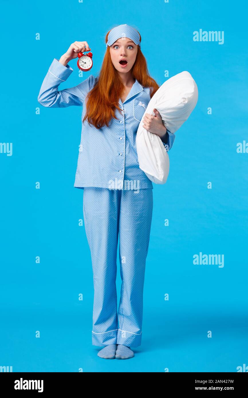 Vertical fulllength shot shocked and startled cute redhead female in