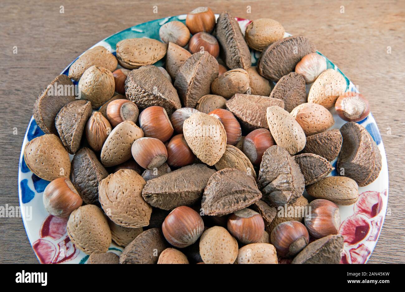 Mixed nuts in shells, Brazil, Hazel and Almond displayed on plate