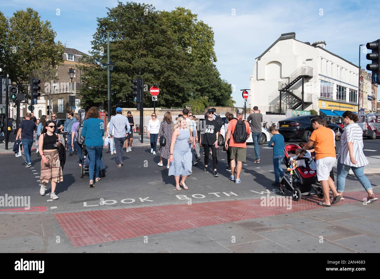 People crossing the road at Highbury Corner pedestrian crossings, London Borough of Islington