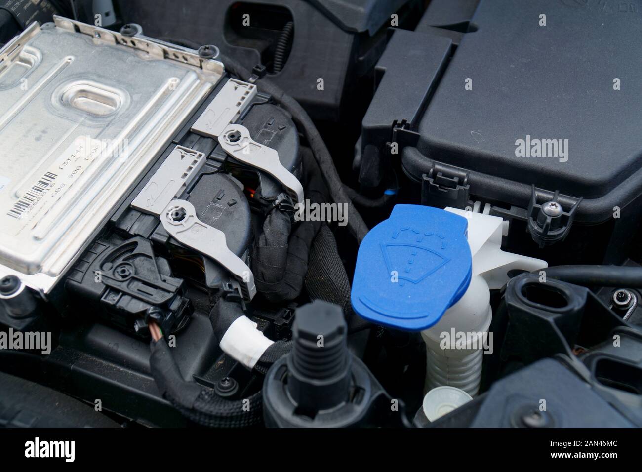 ECU and windscreen washer refill in engine bay of a car Stock Photo