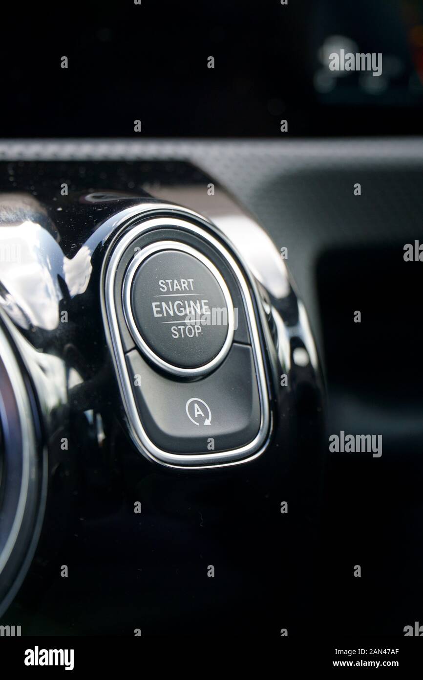Starter button in a modern car interior, with auto start/stop deactivation button Stock Photo