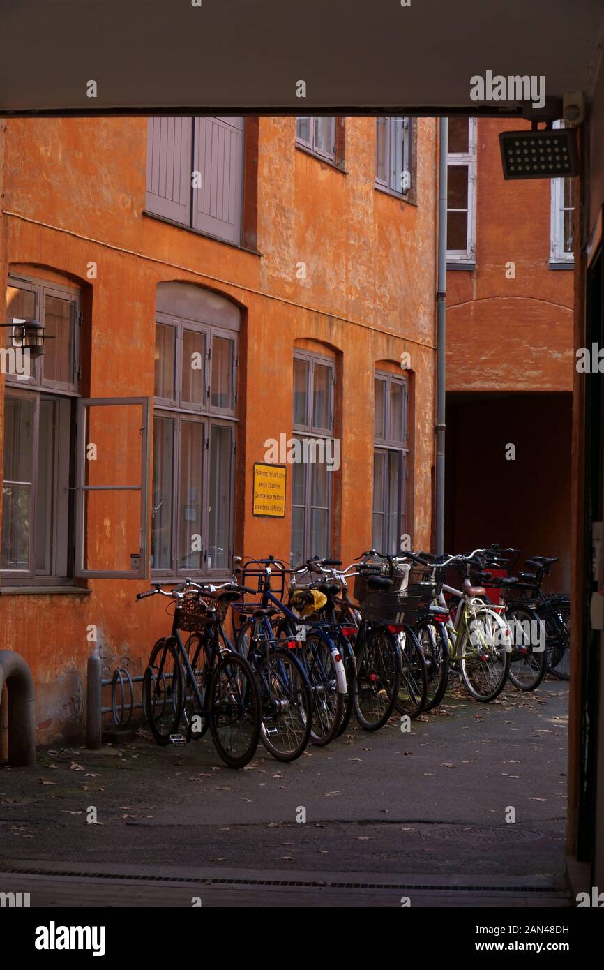 Row of parked bicycles by a building Stock Photo