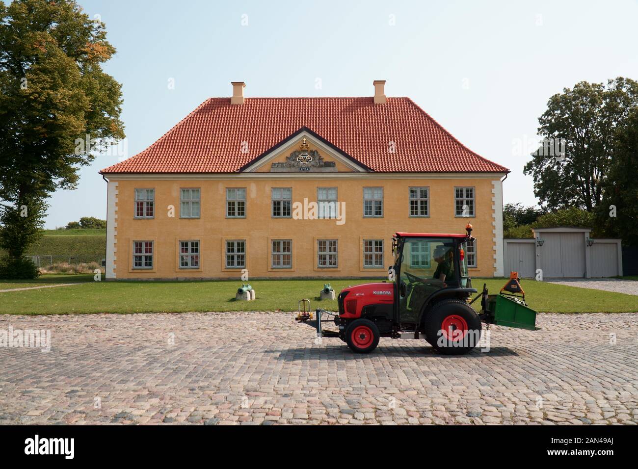 Tractor drives in front of a building on the island of Kastellet in Copenhagen, Denmark Stock Photo