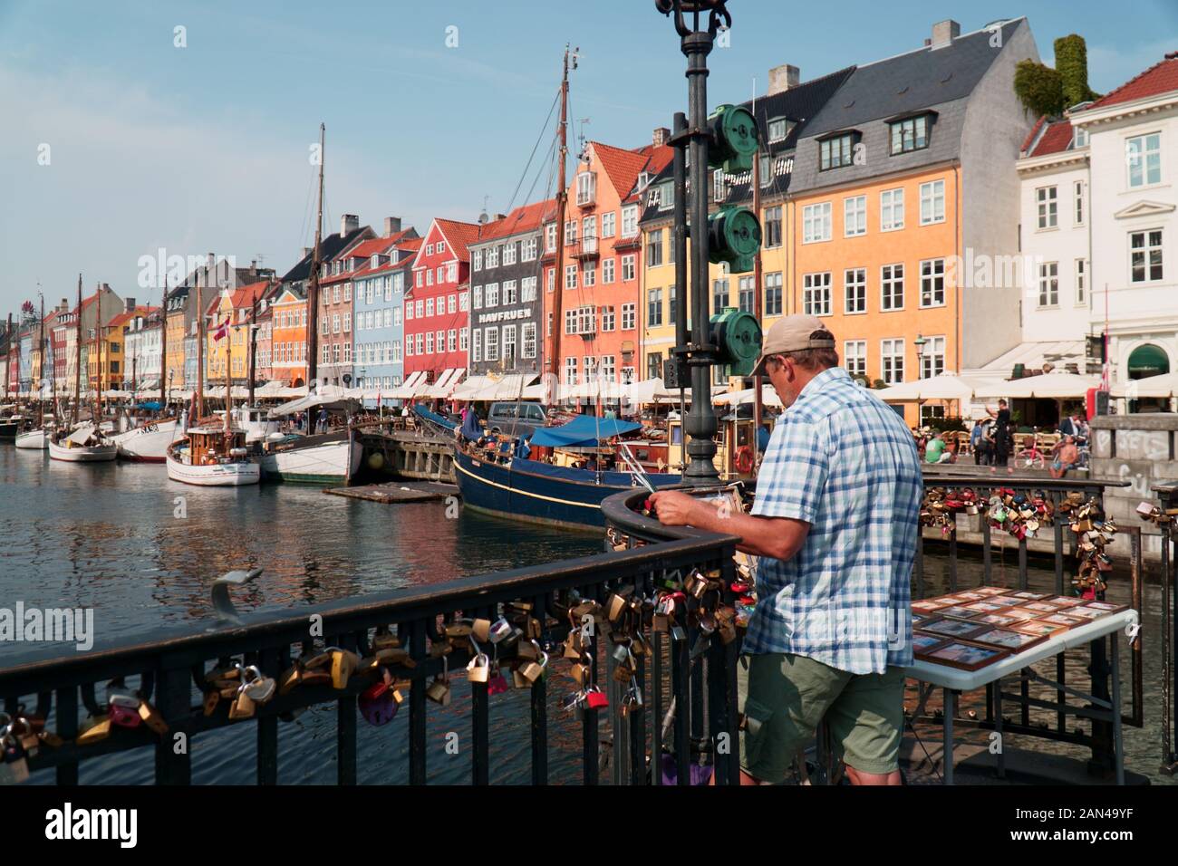 Man painting on a bridge in Nyhavn, Copenhagen Stock Photo