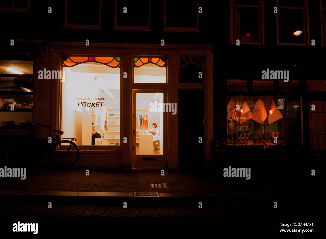 Brightly lit boutique store at night in Amsterdam, Netherlands Stock Photo