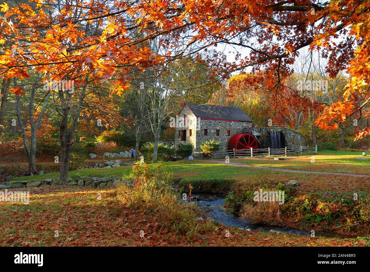 The Wayside Inn Grist Mill with water wheel and cascade water fall in Autumn. Stock Photo