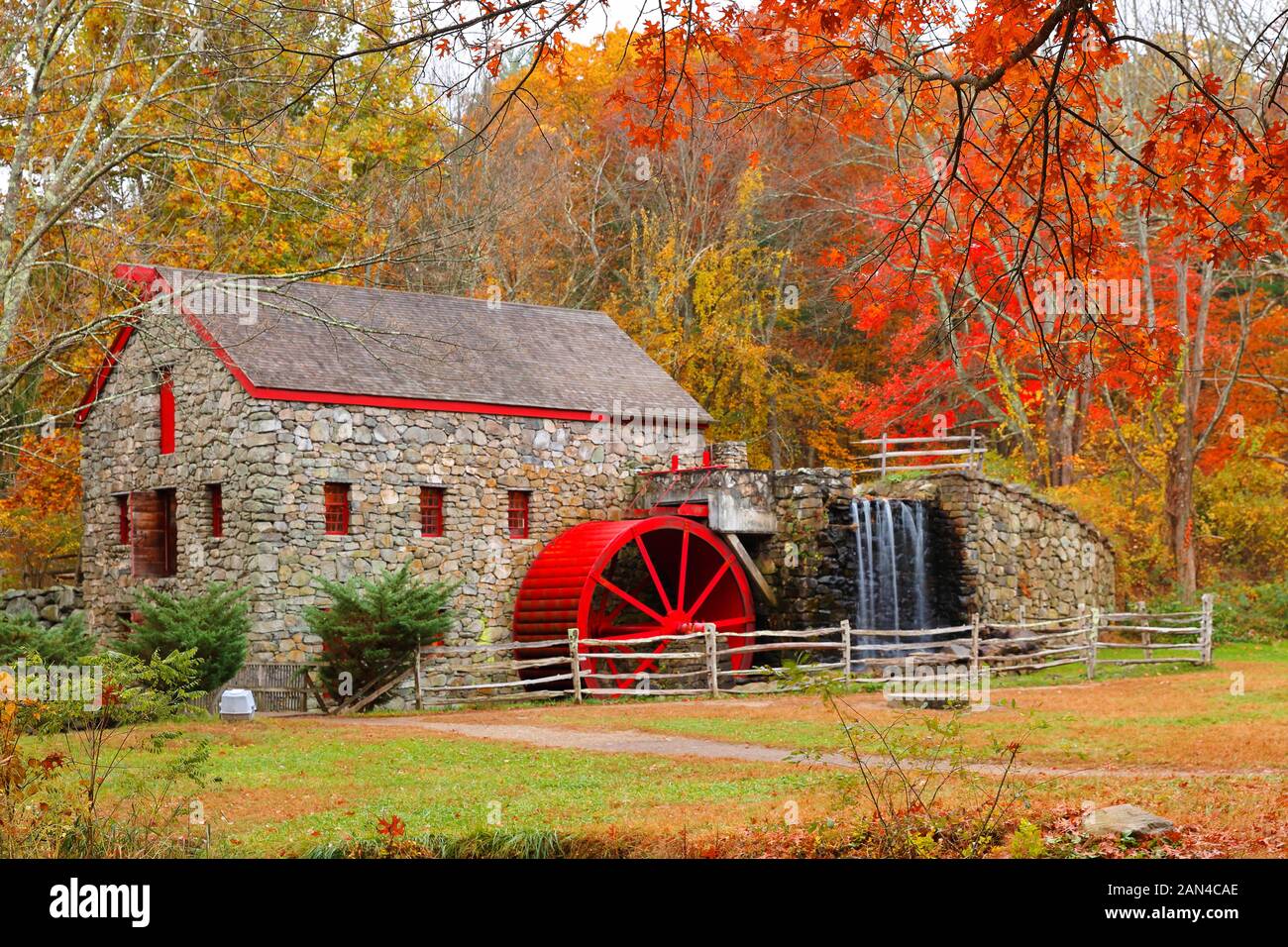 The Wayside Inn Grist Mill with water wheel and cascade water fall in Autumn. Stock Photo