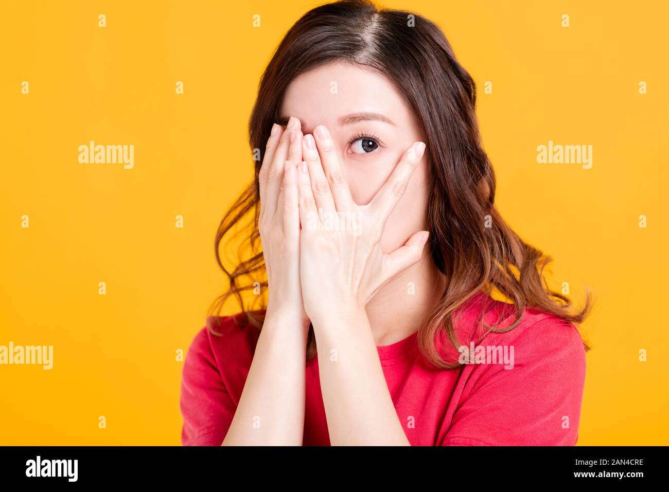 scared young asian woman with hand cover face Stock Photo