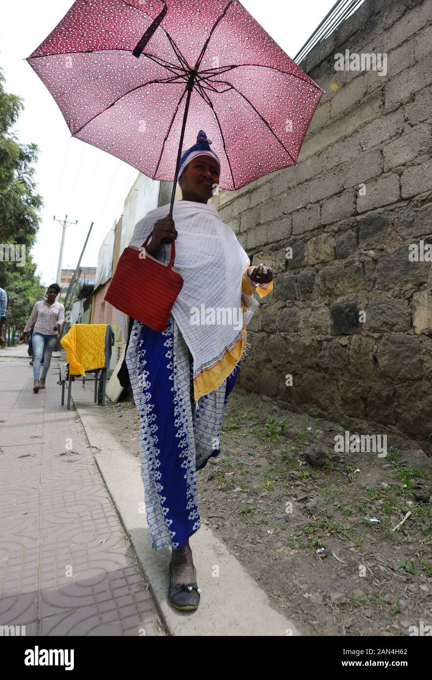 Fashionable Ethiopian woman holding an umbrella. Stock Photo