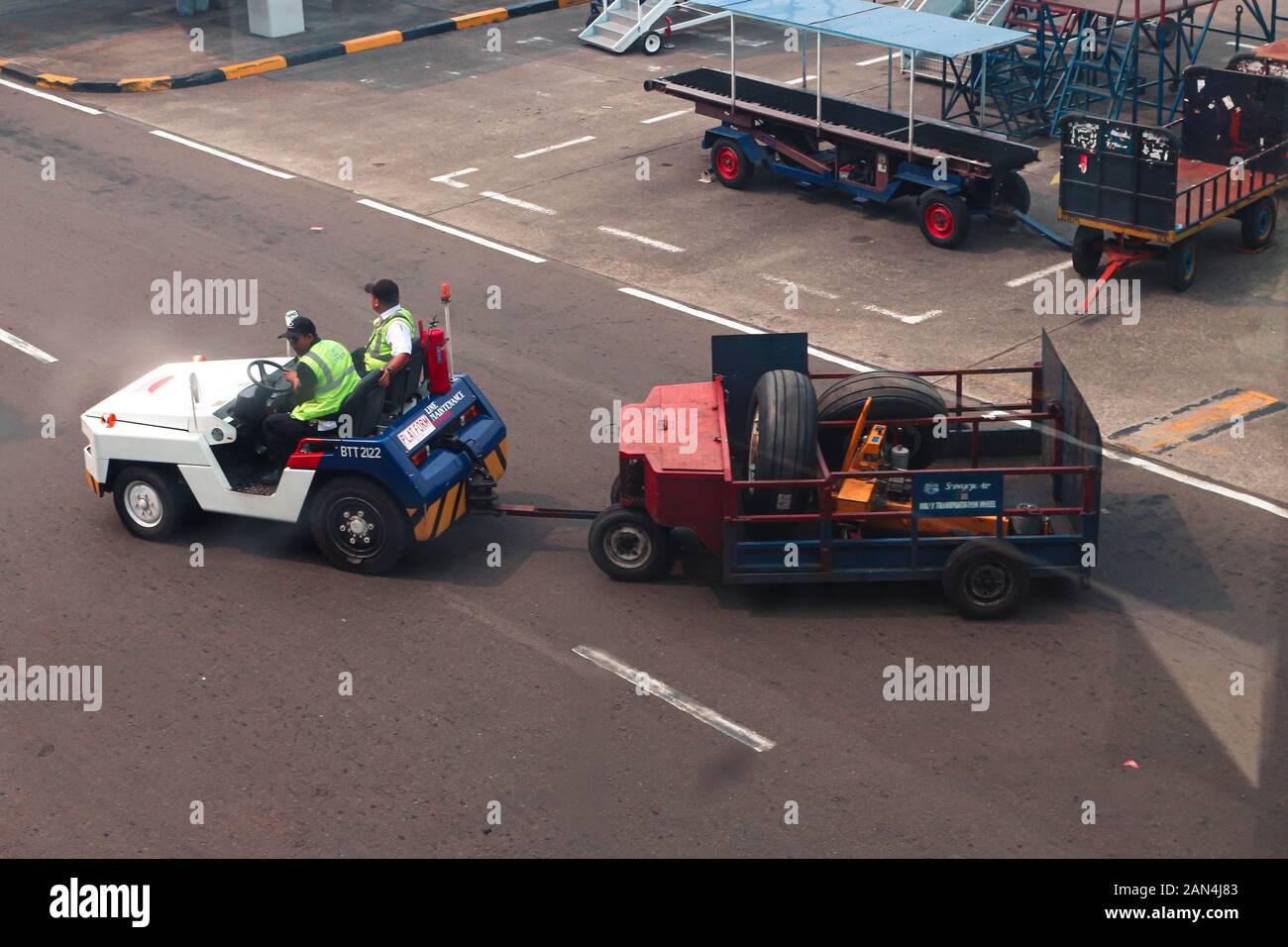 Picture of Sriwijaya Air Ground Handling Unit, Luggage Car with the Carriage Stock Photo