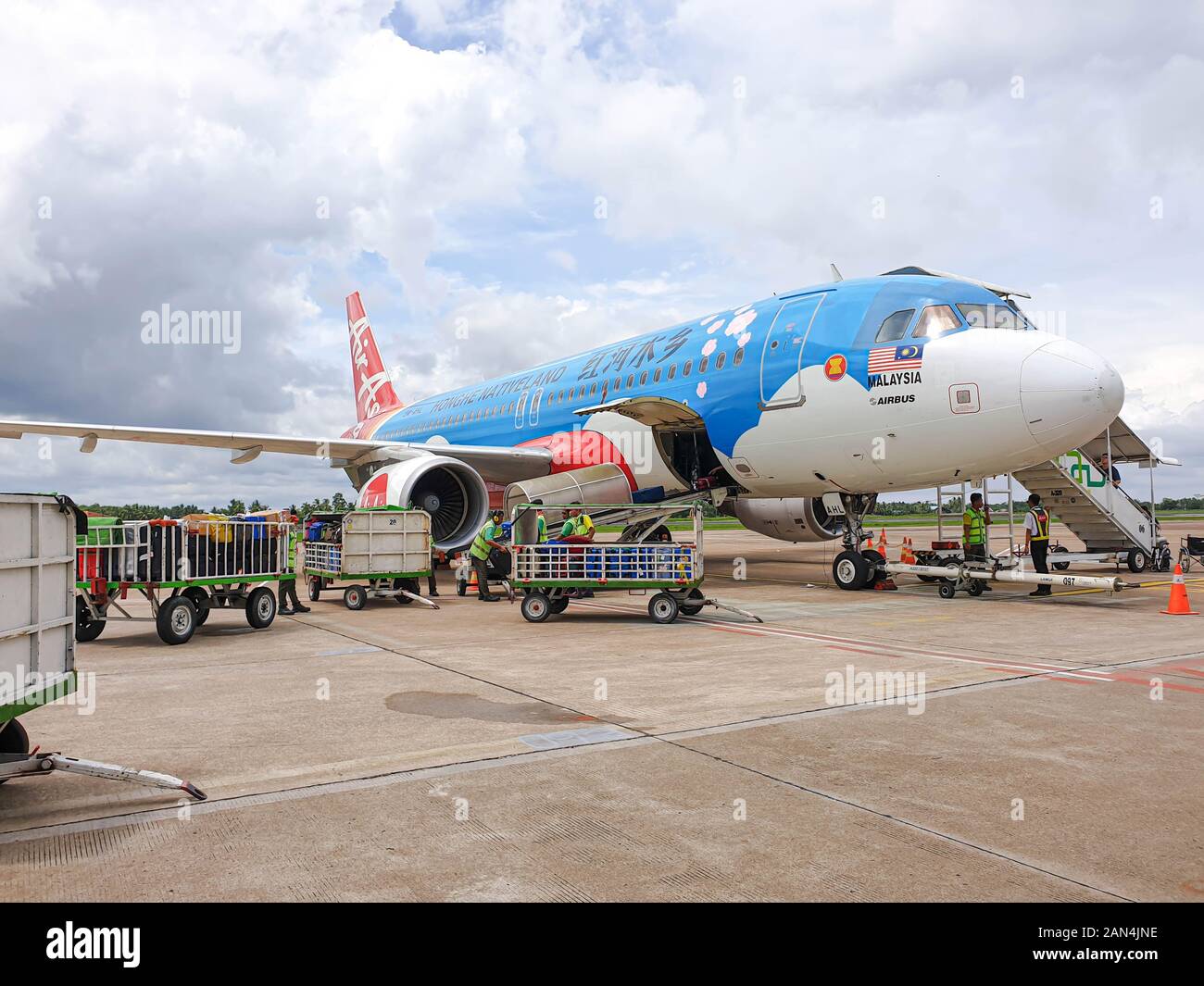AirAsia Airbus A320-216 9M-AHL (Hong He Native Land Livery) at Supadio International Airport bound for Kuala Lumpur, Malaysia Stock Photo