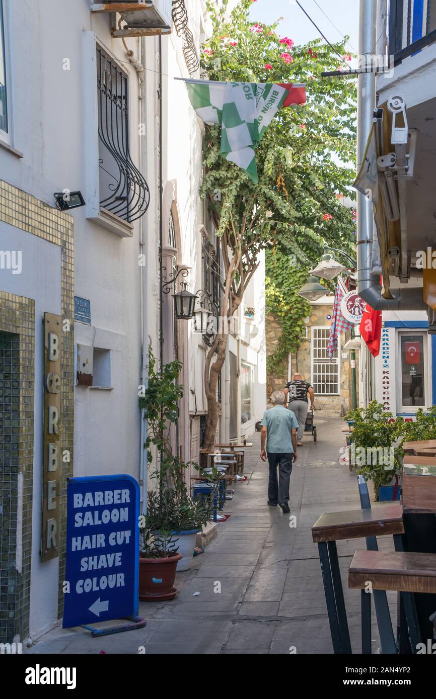 Bodrum, Turkey - September 15th 2019: Man walking down a typical street in the old town, The town is a popular tourist destination. Stock Photo