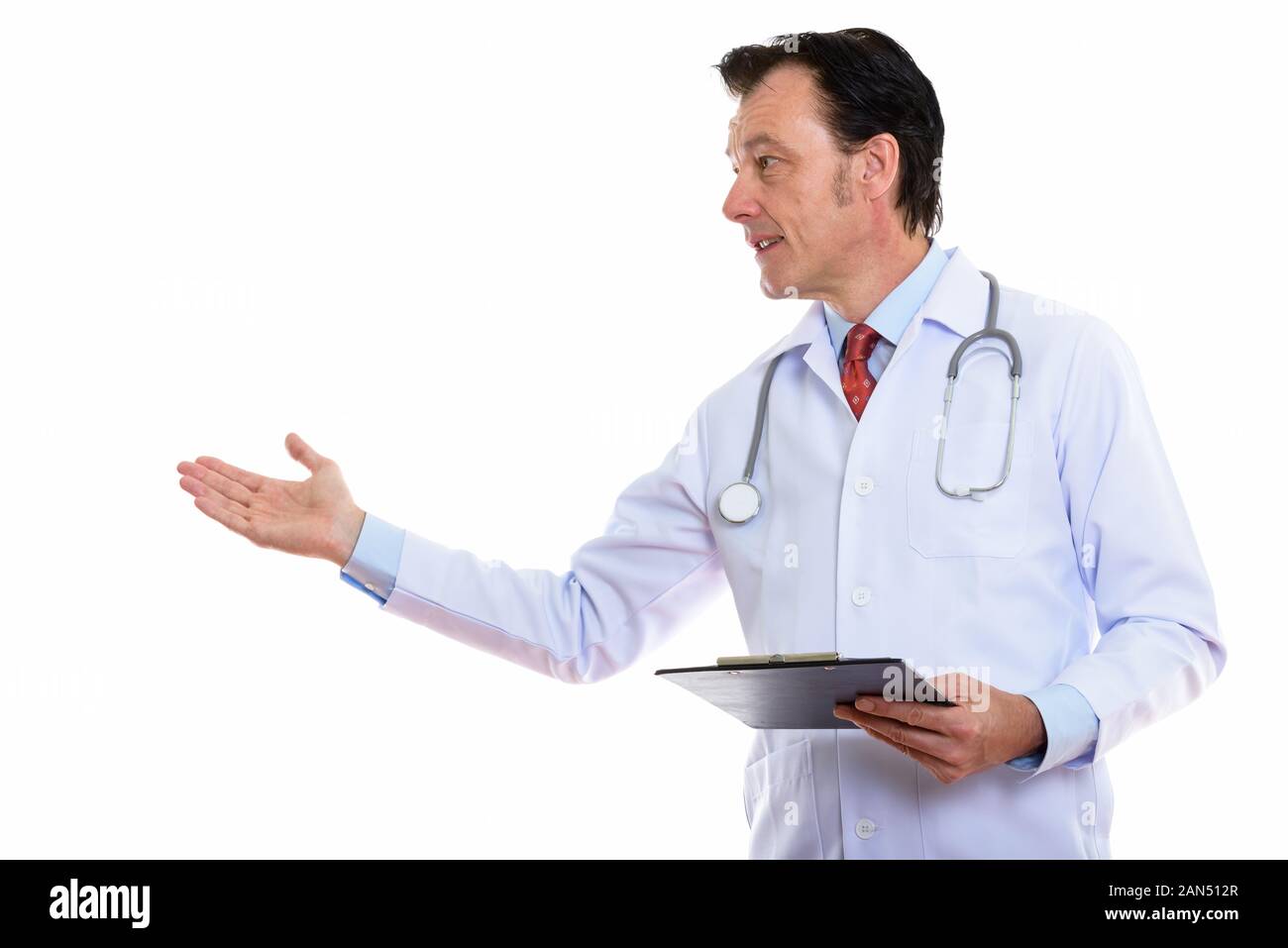 Mature handsome man doctor presenting something with clipboard Stock Photo