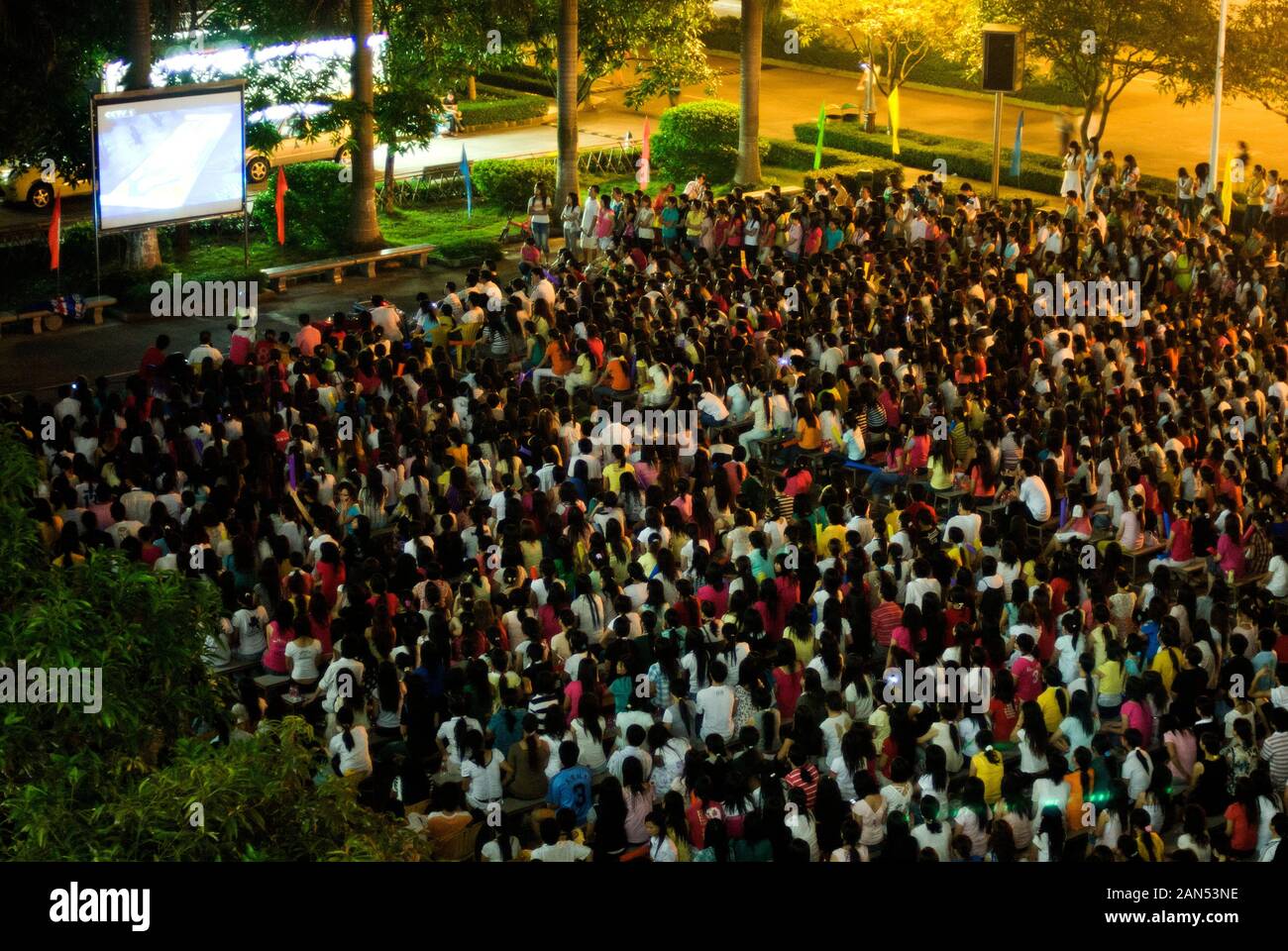 --FILE--Migrant workers gather to watch the opening ceremony of 2008 Beijing Summer Olympics opening ceremony in Dongguan city, south China's Guangdon Stock Photo