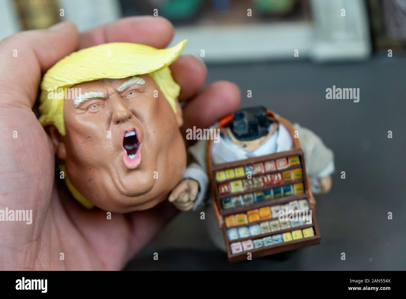 A wacky miniature of American president Donald Trump selling cigarettes and Japanese prime minister Shinzo Abe selling pop corns on the street were pr Stock Photo