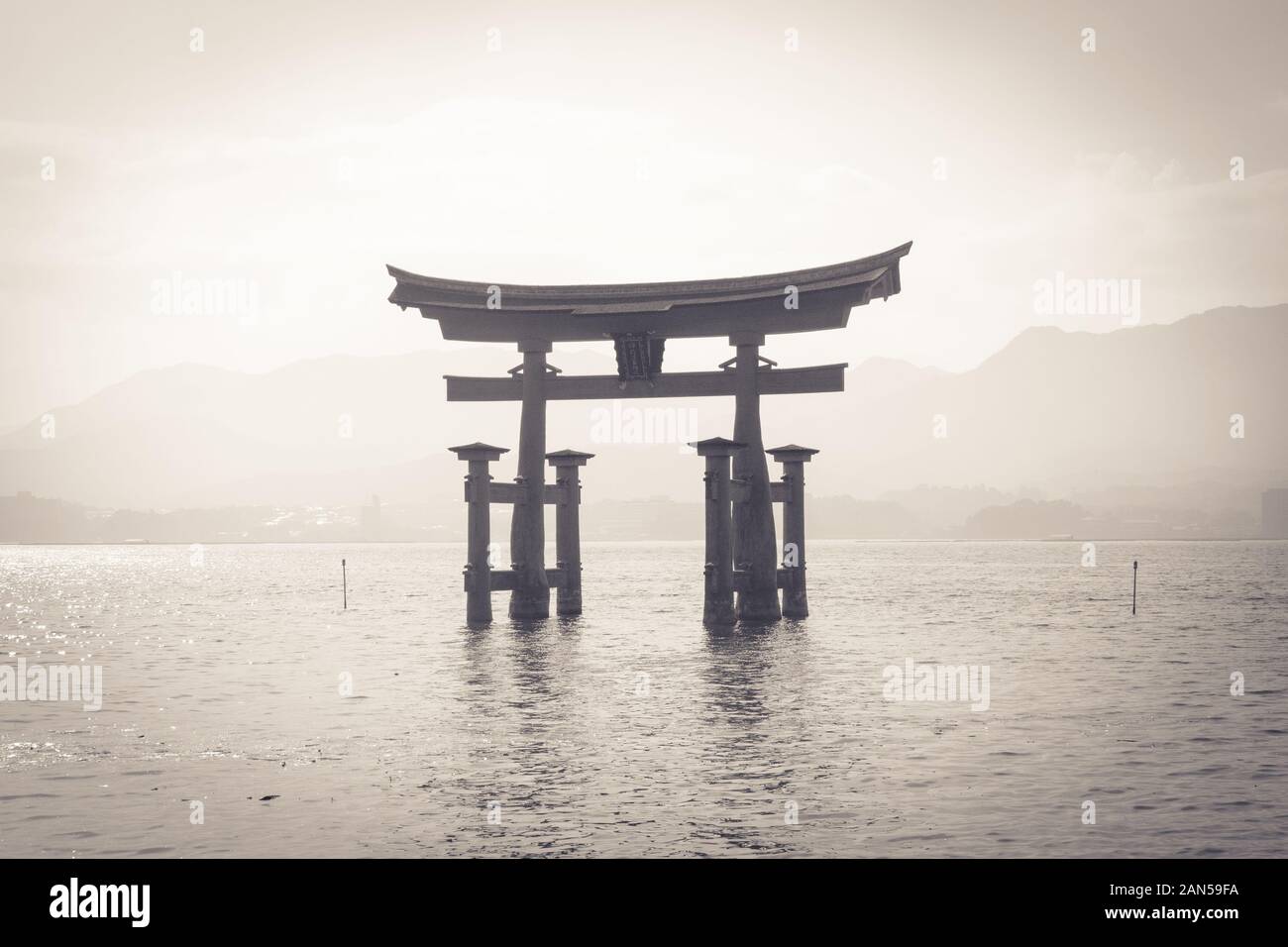 Black-and-white floating torii gate of Itsukushima Shrine (Itsukushima-jinja) on the island of Miyajima (Itsukushima) in Hiroshima Prefecture, Japan. Stock Photo