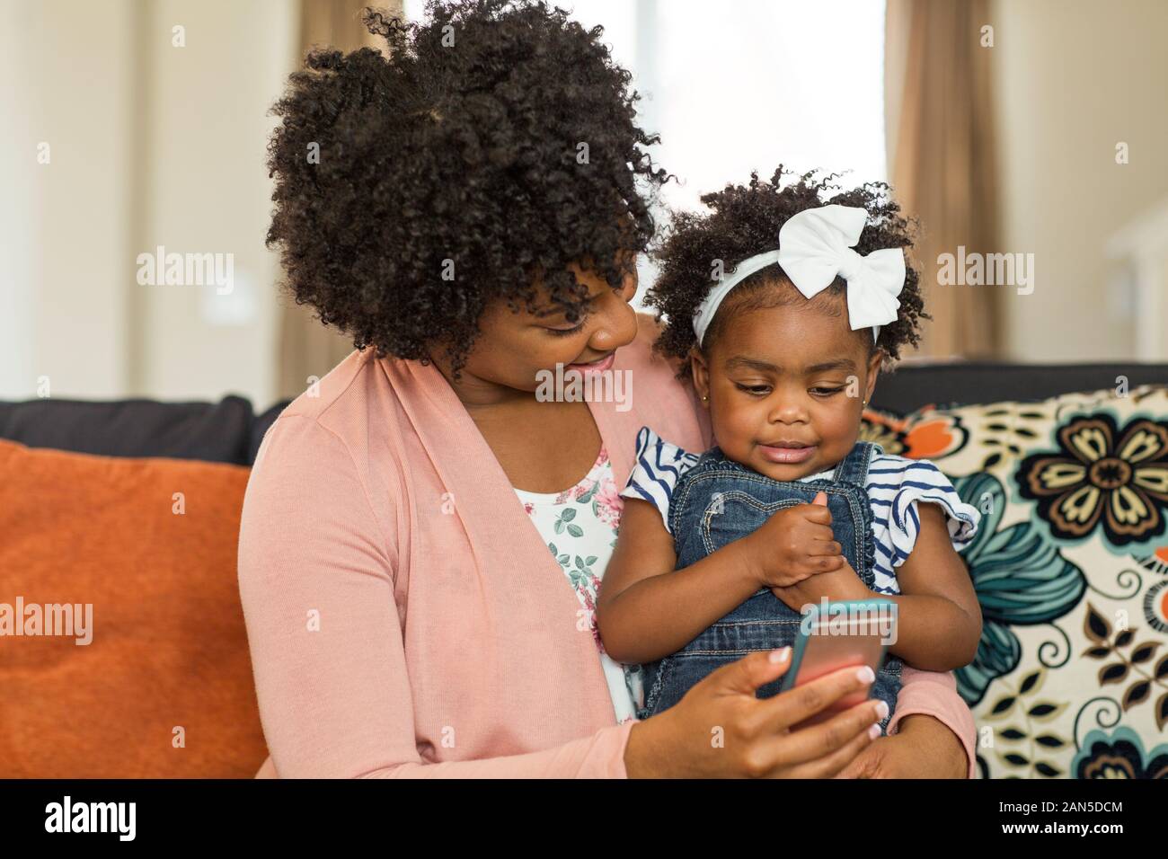 African American mother and daughter playing on the phone. Stock Photo