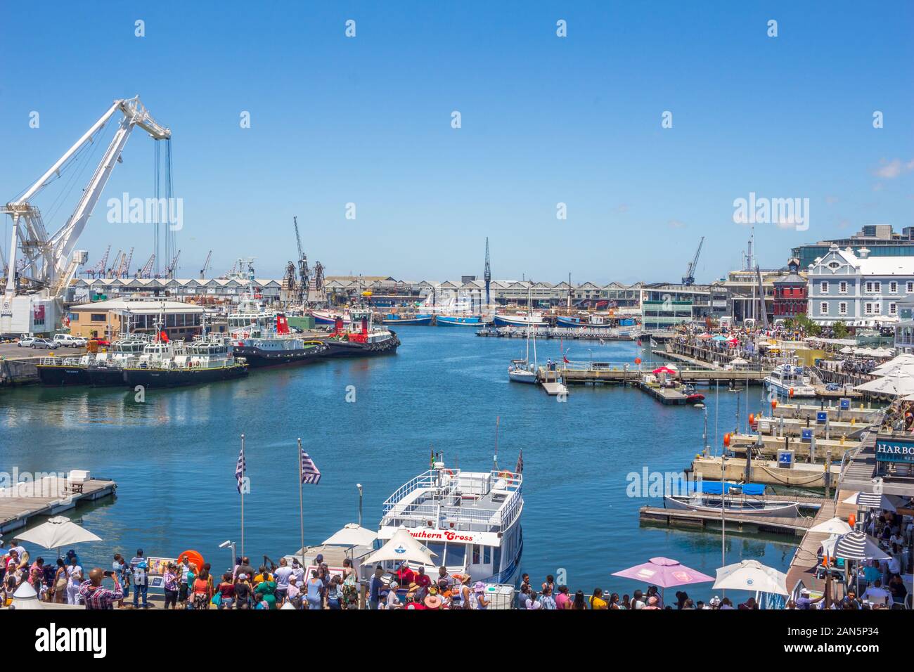 CAPE TOWN , SOUTH AFRICA - 01 JANUARY 2020: V & A Waterfront with many tourists onNew Years day at the Cape Town harbour with Old Port Captain's build Stock Photo