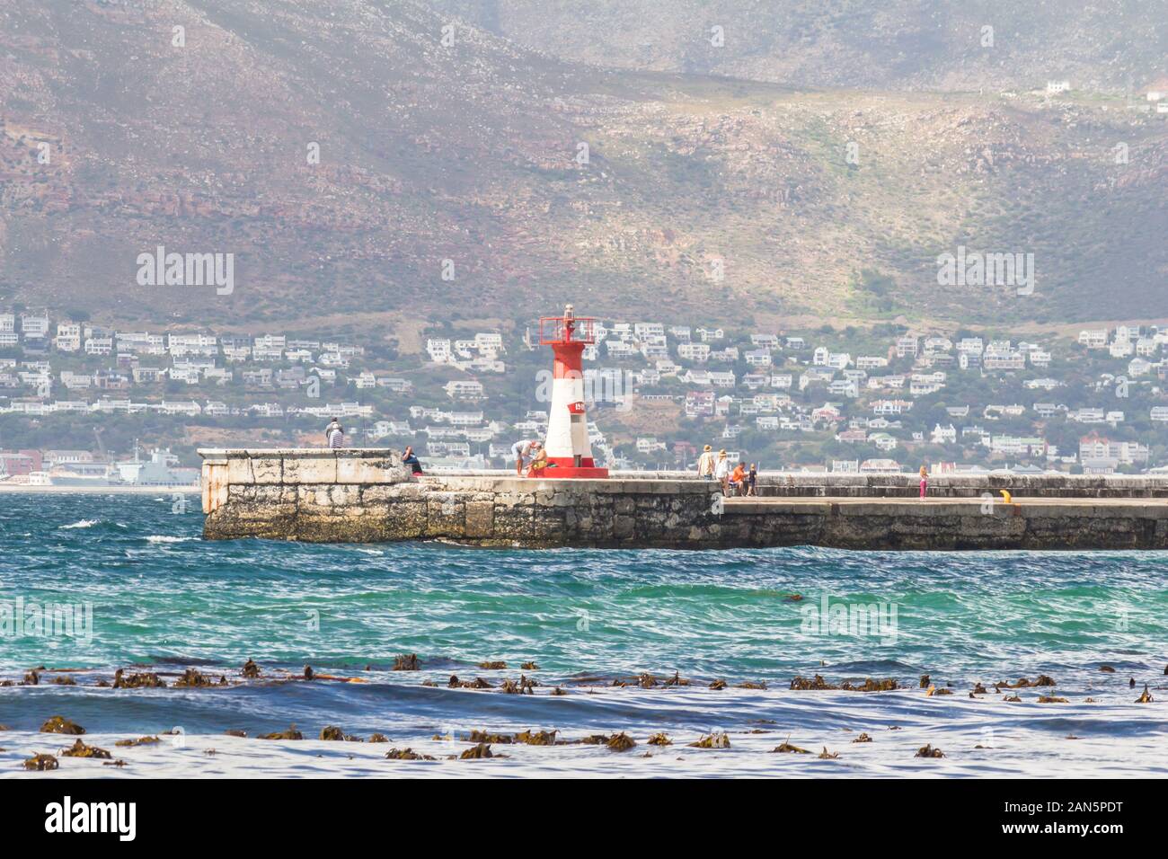 CAPE TOWN , SOUTH AFRICA - 03 JANUARY 2019: View from St James beach over Kalk Bay recreational harbour and breakwater lighthouse built in 1919  in |F Stock Photo