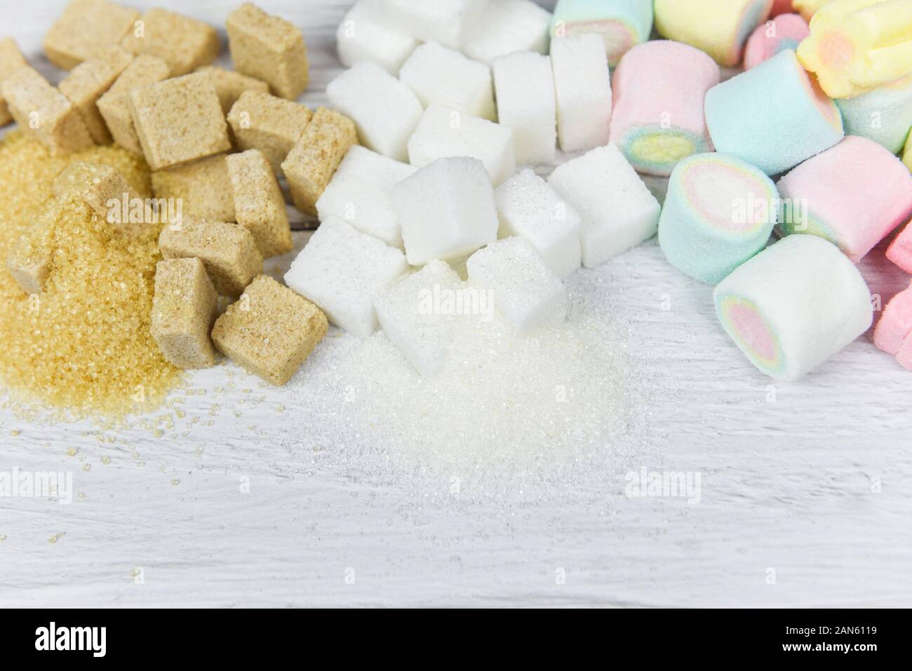 Brown sugar , White sugar , sugar cubes and colorful candy sweet on the table background / No sugar in diet causes obesity diabetes and other health p Stock Photo